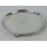 A Georgian HM silver salver raised over three shaped feet,