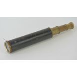 A 19thC three draw brass telescope with American cloth grip, 43cm fully extended.