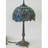 A small modern Tiffany style table lamp with blue leaded glass shade having dragonfly designs,