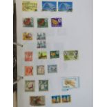 A Stuart 'Gold Crest' loose leaf album and a collection of Middle Eastern and African stamps,