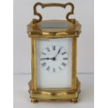 A French brass five glass carriage clock having white enamel dial, black Roman numerals,