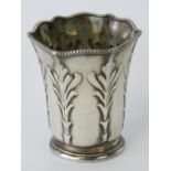 A delightful Taffany & Co silver plated tot cup having embossed foliate pattern upon, fluted rim,