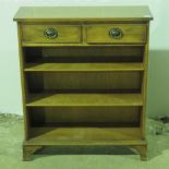 A contemporary yew wood bookcase with twin drawers over, 76cm wide.