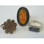 Three silver rings; a Baltic amber ring size N-O, an eight sapphire ring, size K,