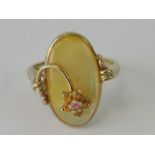 A 9ct gold and mother of pearl ring having pink and orange floral design, stamped 9k, size L-M.