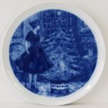 A decorative German hanging plate with blue and white design upon.