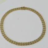 A 14ct gold necklet having two row triangular pattern,