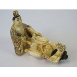 Two 19th century carved ivory netsuke figurines being a male and female in erotic pose,