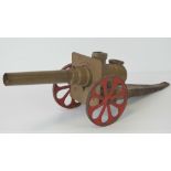 A 'Big Bang' carbide metal toy cannon c1940-50's, 44cm in length, with red painted wheels.