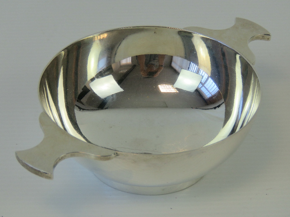 A HM Scottish silver quaich of plain form having twin handles and 10cm dia bowl,