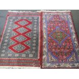 Two small woolen rugs in red ground having geometric patterns,