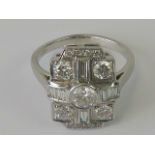 An 18ct white gold Art Deco style diamond cocktail ring having central round cut brilliant (approx