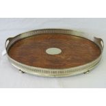 An oak serving tray raised over four ball feet and having silver plated pierced gallery, 51 x 36cm.