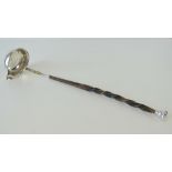 A white metal toddy ladle having twisted whale bone handle and white metal terminal, 34cm in length.