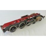 A scale model steam locomotive wheel base having five pairs of wheels, driving piston to each side,