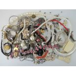 A quantity of assorted vintage and modern costume jewellery within Estee Lauder vanity case,