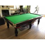 A fine three quarter size snooker table by Titan raised over six reeded legs,