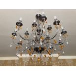 A good contemporary steel and glass Classically shaped chandelier having fifteen single bulb