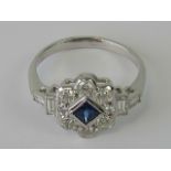 An 18ct white gold sapphire and diamond ring having central square cut sapphire surrounded by a