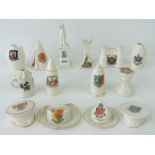 A quantity of commemorative ceramic wares in the form of hats, bullets, railway lanterns,