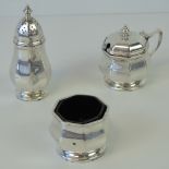 An octagonal HM silver cruet set comprising pepperette, salt with blue glass liner,