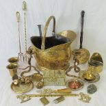 A copper coal helmet containing a quantity of assorted brass ware within.