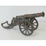 A vintage cast decorative table cannon measuring 33cm in length.