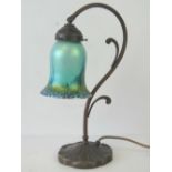A modern Art Nouveau style table lamp with iridescent lustre shade and lily pad leaf foot.