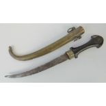 An Eastern dagger having curved steel blade, engraved brass guard and hard wood handle,