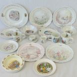 A quantity of Wedgwood Beatrix Potter nursery ceramics and Royal Doulton Wind in the Willows plates.