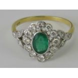 A delightful 18ct gold emerald and diamond floral ring, central oval cut emerald (approx 0.46ct / 4.