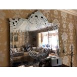 A large and impressive contemporary Venetian style wall mirror measuring 177 x181cm.