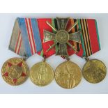 Four Russian medals with ribbons on bar, together with Russian Order.