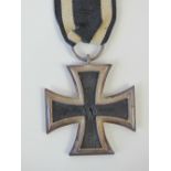 A WWI German Imperial Iron Cross with ribbon.
