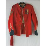 A British red tunic, with colour sergeant stripes and sash, 24th Regiment replica badges,