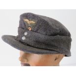 A reproduction WWII German Luftwaffe ski cap with cloth eagle insignia and fold down ear flaps.