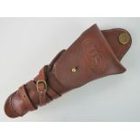 A brown leather holster complete with strap, embossed 'US'.