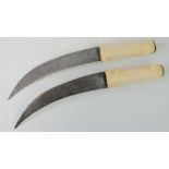 A pair of Eastern daggers having bone handles, blade length 21cm approx.