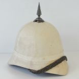 An original canvas covered tropical German pith helmet having leather lining and articulated chin