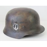 A fine reproduction WWII German SS helmet having single decal, woodland camouflage paint,