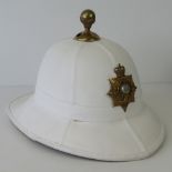 A Royal Marine Officers pith helmet with brass Gibraltar badge upon,