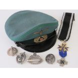 A quantity of replic WWII German medals and badges together with a replica WWII German Officers