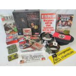 A quantity of assorted WWII and later military themed items including signs, dolls, DVDs, etc.