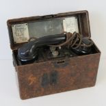 A WWII German field telephone having original receiver and bakelite case.