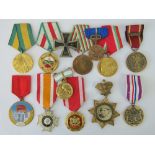 A quantity of medals with ribbons including Russian 2nd Class Motherhood medal,