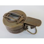 A reproduction military style brass compass marked T.G.Co Ltd London.