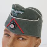 A German WWII Army Officers forage cap having red piping and silver thread (Artillery troops) and