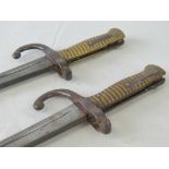 A good pair of late 19th century French sword bayonets each having beehive grip,