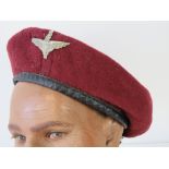 A Parachute Regiment red beret with badge.