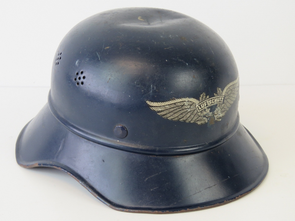 A WWII German Luftschutz helmet having single decal to front, label within,